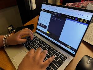 Close-up of student working on codeacademy database activity